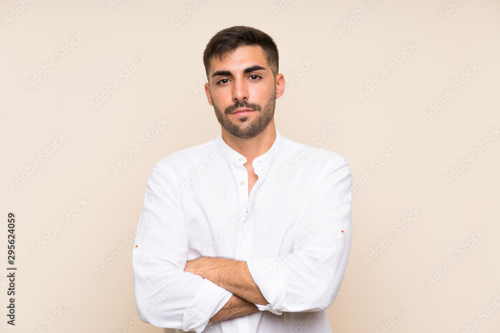Handsome man with beard over isolated background keeping arms crossed Handsome man with beard over isolated background keeping arms crossed