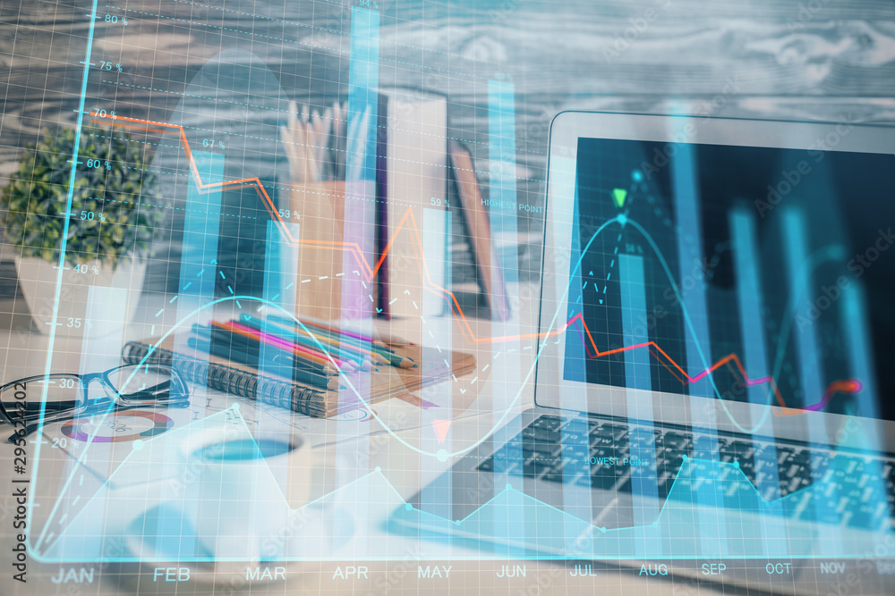 Financial market graph hologram and personal computer on background. Multi exposure. Concept of forex. Financial market graph hologram and personal computer on background. Multi exposure. Concept of forex.