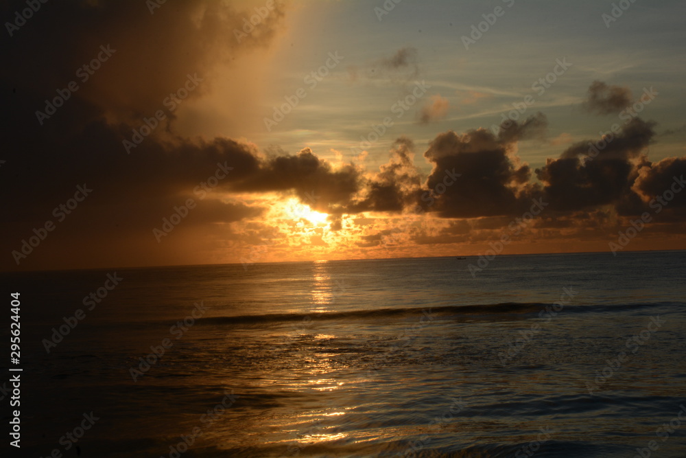 Sunrise over the sea on a partly cloudy dawn