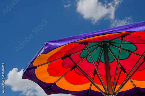 A Striped and Colorful Umbrella under Nice Sky