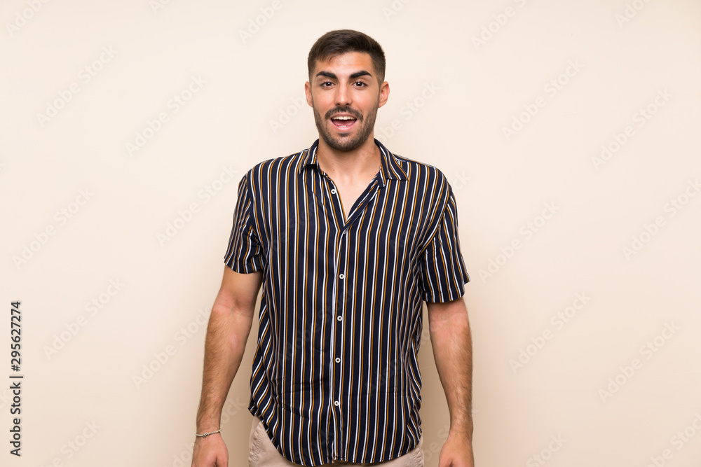 Handsome man with beard over isolated background with surprise facial expression Handsome man with beard over isolated background with surprise facial expression