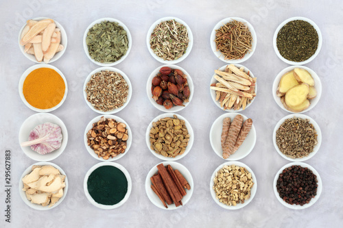 Asthma and respiratory relieving herbs, spice and supplement powders used in natural and chinese herbal medicine in porcelain bowls. Flat lay.