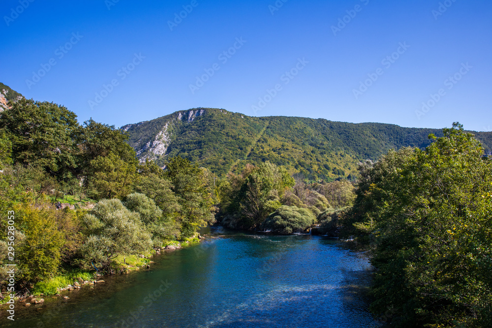 Beautiful and turquoise river Una in canyon on the Croatian and Bosnia and Herzegovina border. Forest and mountains next to the river. Beautiful and turquoise river Una in canyon on the Croatian and Bosnia and Herzegovina border. Forest and mountains next to the river.