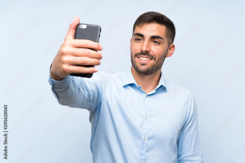 Young handsome man with his mobile making a selfie Young handsome man with his mobile making a selfie