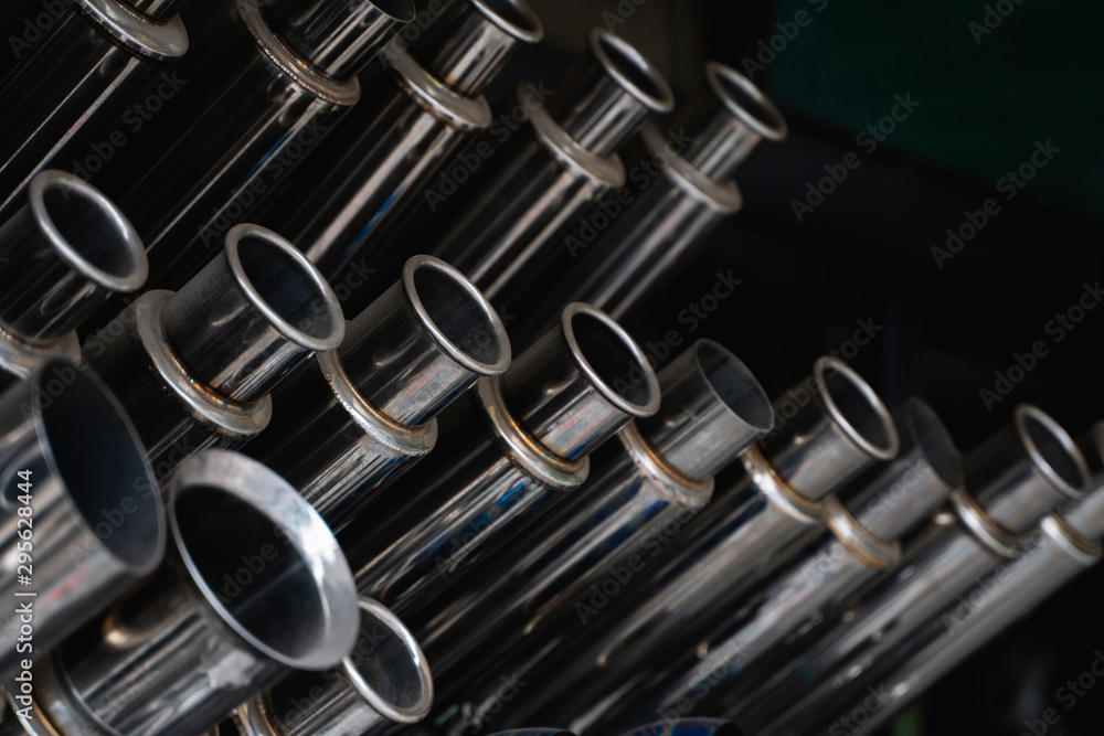 New and used motorcycle exhaust chrome pipes in a motorcykles shop or in service center. New and used motorcycle exhaust chrome pipes in a motorcykles shop or in service center.