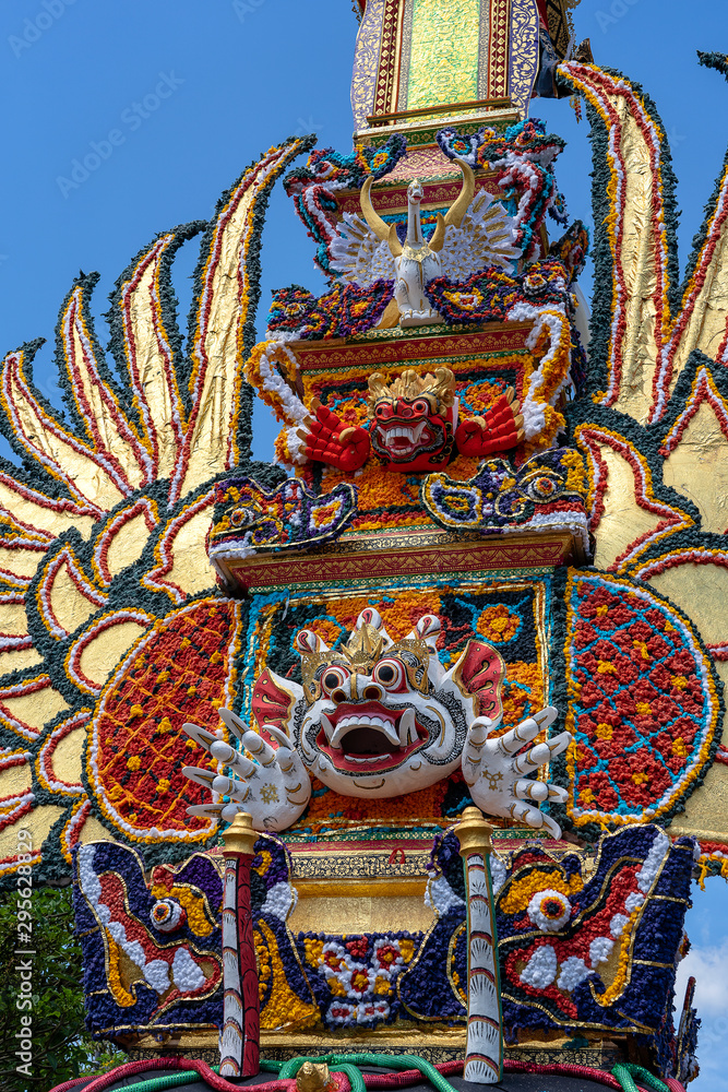 Fototapeta premium Bade cremation tower with traditional balinese sculptures of demons and flowers on central street in Ubud, Island Bali, Indonesia . Prepared for an upcoming cremation ceremony