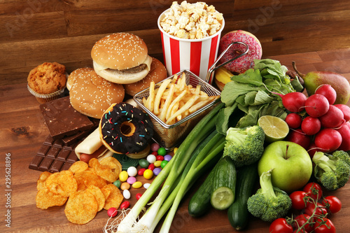Fototapeta Naklejka Na Ścianę i Meble -  healthy or unhealthy food. Concept photo of healthy and unhealthy food. Fruits and vegetables vs donuts and fast food