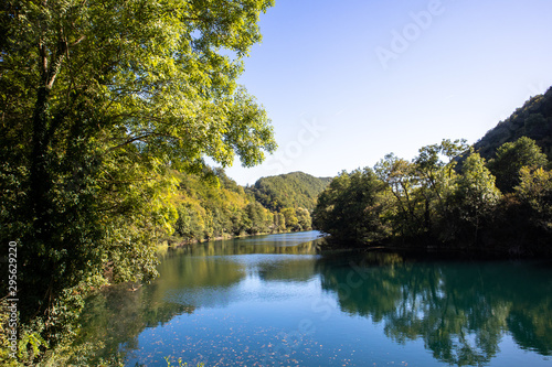 Beautiful and turquoise river Una in canyon on the Croatian and Bosnia and Herzegovina border. Forest and mountains next to the river.