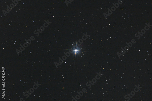 Closeup of the star Sadr in Cygnus constellation, with many stars as background in the deep space.