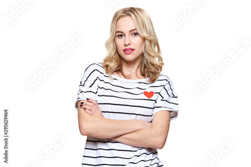 Attractive young confident woman wearing casual clothes standing with crossed arms, looking at camera. Woman portrait over white background.