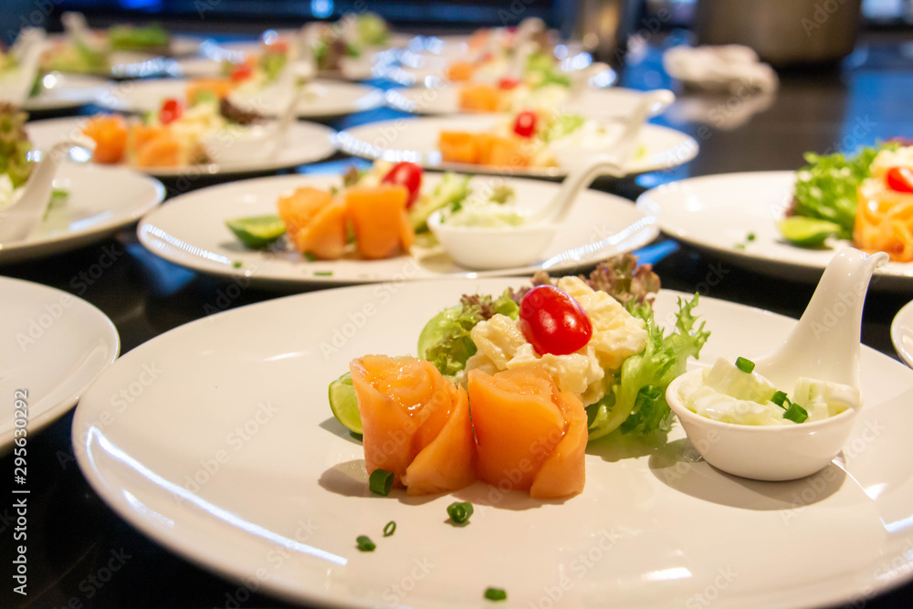 A smoke salmon salad on white plate A smoke salmon salad on white plate