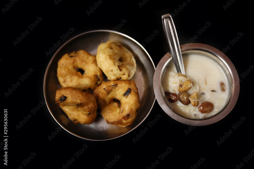 Semiya payasam (Mithai) Kerala,Sweet seviyan kheer or Payasam with vada a popular south Indian food on black background, Top view Semiya payasam (Mithai) Kerala,Sweet seviyan kheer or Payasam with vada a popular south Indian food on black background, Top view