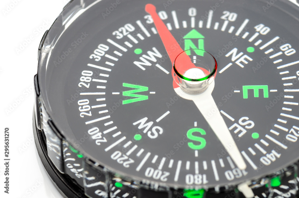 close up of compass on white background, travel or science concept close up of compass on white background, travel or science concept