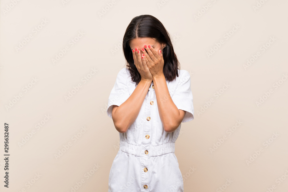 Young woman over isolated background with tired and sick expression Young woman over isolated background with tired and sick expression