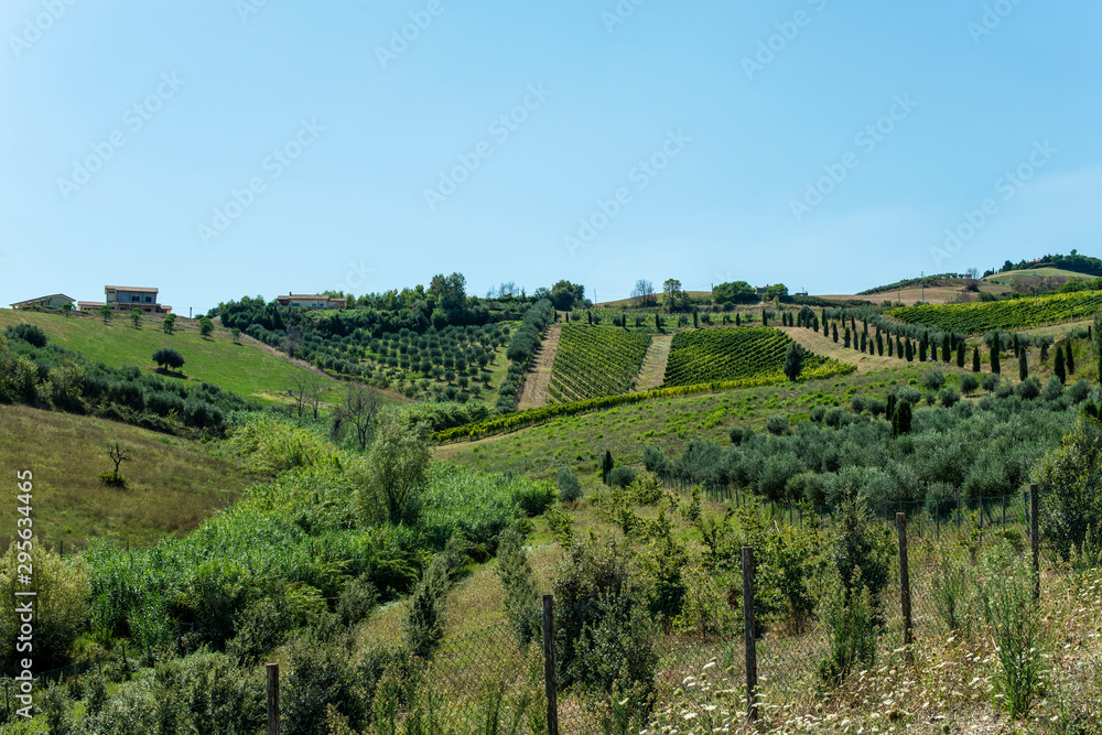 Roads, hills and agricultural land in Italy. Landscape with cypresses