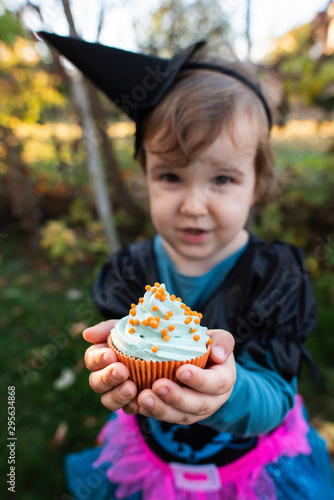 A little girl with a Halloween costume.