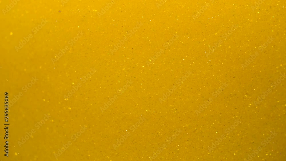 Golden Wave Background. Art Gold Background. Golden Sand , Dust Creating Abstract Cloud Formations. Slow Motion. Gold Texture. Amazing Metamorphosis Sparkle Shiny Particles Flow With Underwater. Golden Wave Background. Art Gold Background. Golden Sand , Dust Creating Abstract Cloud Formations. Slow Motion. Gold Texture. Amazing Metamorphosis Sparkle Shiny Particles Flow With Underwater.