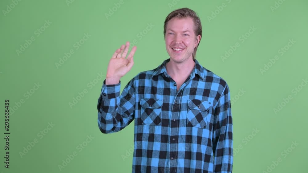 Happy young handsome hipster man waving hand Happy young handsome hipster man waving hand