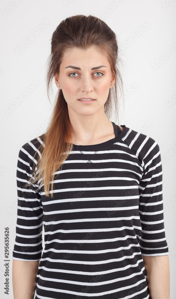 Portrait of a beautiful young girl in a striped sweater Portrait of a beautiful young girl in a striped sweater