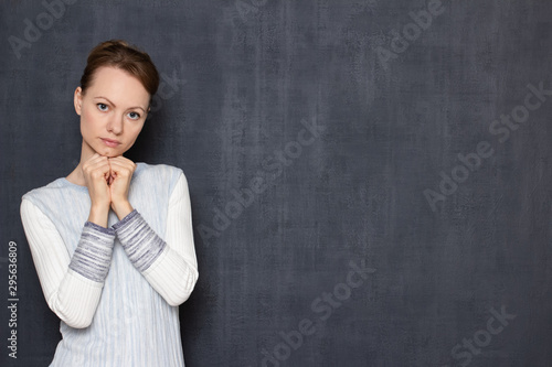 Portrait of pensive young woman waiting or listening somebody