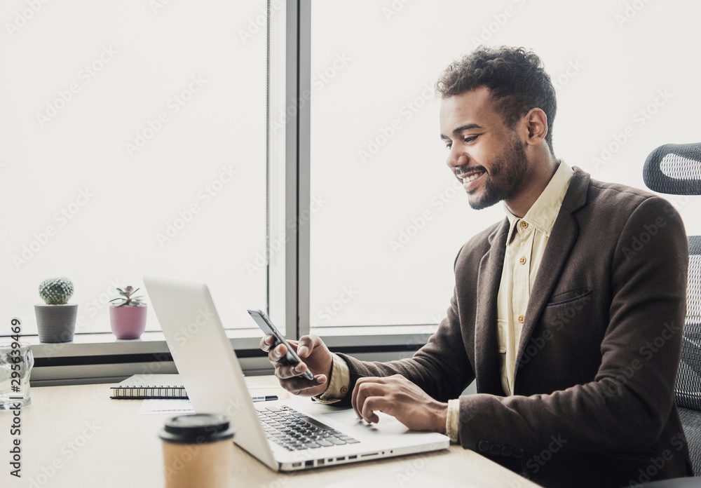 Businessman working on computer, Young man professional using laptop and smart phone in the office, Management, finance, business concept Businessman working on computer, Young man professional using laptop and smart phone in the office, Management, finance, business concept