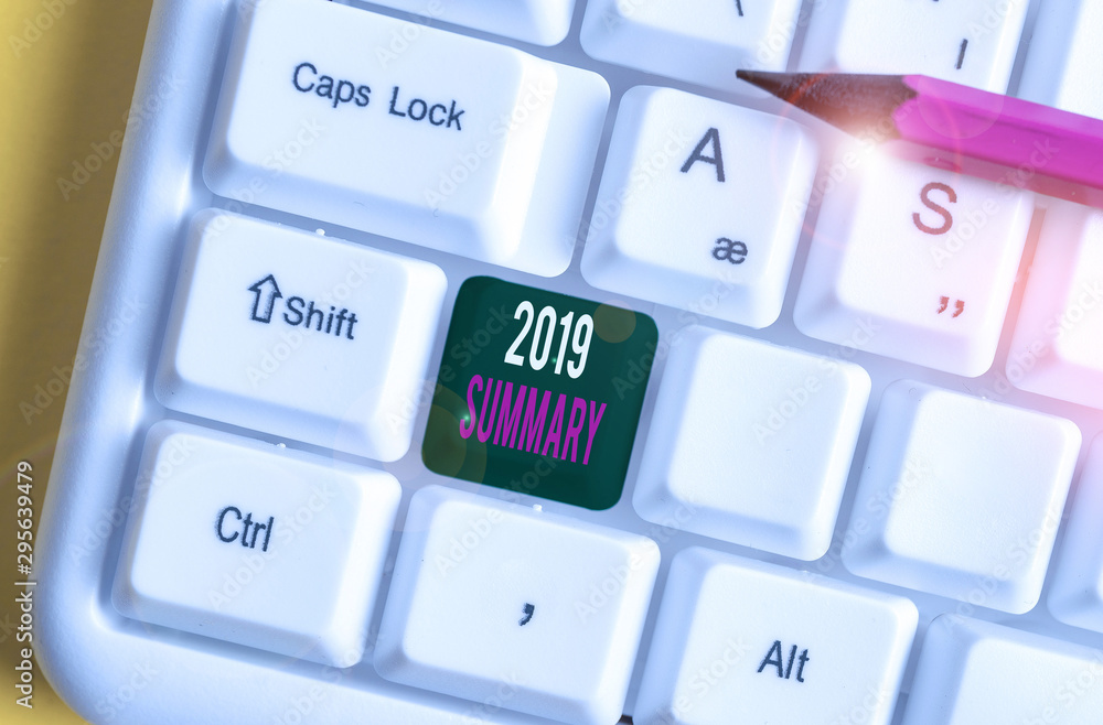 Word writing text 2019 Summary. Business photo showcasing brief comprehensive especially covering the main points of 2019 White pc keyboard with empty note paper above white background key copy space Word writing text 2019 Summary. Business photo showcasing brief comprehensive especially covering the main points of 2019 White pc keyboard with empty note paper above white background key copy space