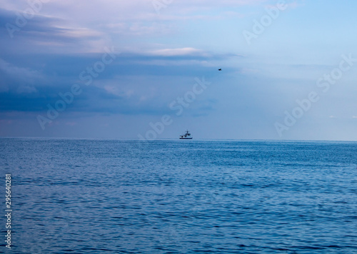 Black Sea Sochi on a hot summer day a boat on the horizon and a plane in the sky