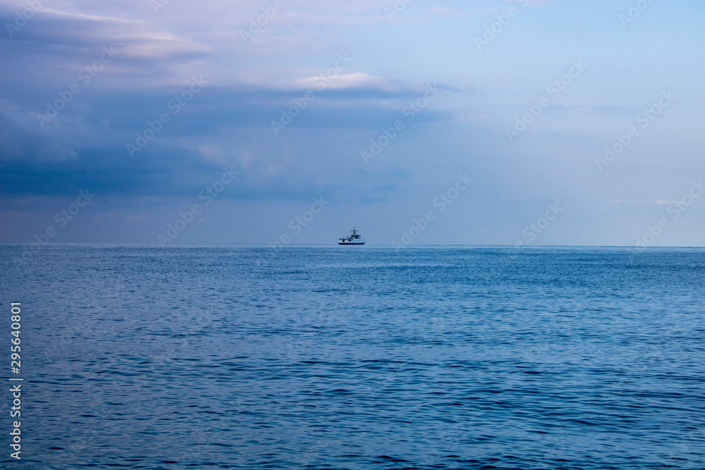 Calm morning Black Sea and boat on the horizon