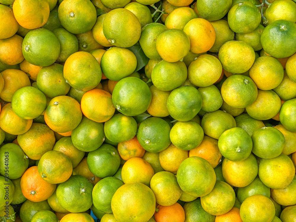 background of green and yellow mandarin, supermarket showcase