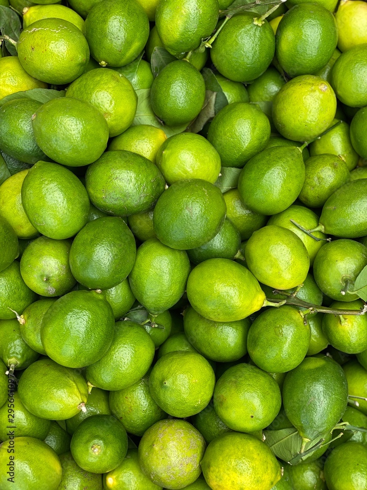 Fresh ripe green limes as background. Lime Citrus Fruits In Fruit Market Fresh ripe green limes as background. Lime Citrus Fruits In Fruit Market