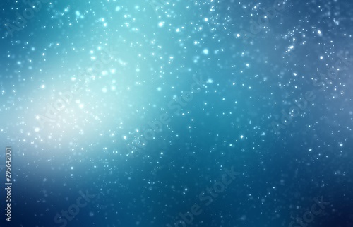 Snowfall on dark cyan background. Winter night outside abstract illustration. Magical flare.