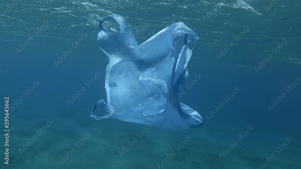 Slow motion, old bllue plastic bag slowly drifting under surface of the ...