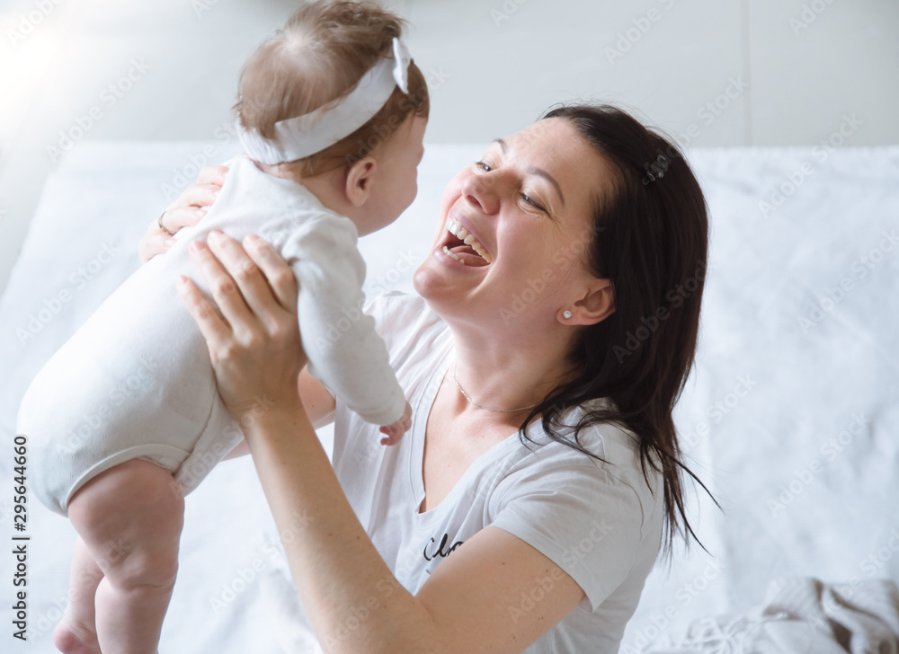 portrait of mom with cute little newborn girl.
