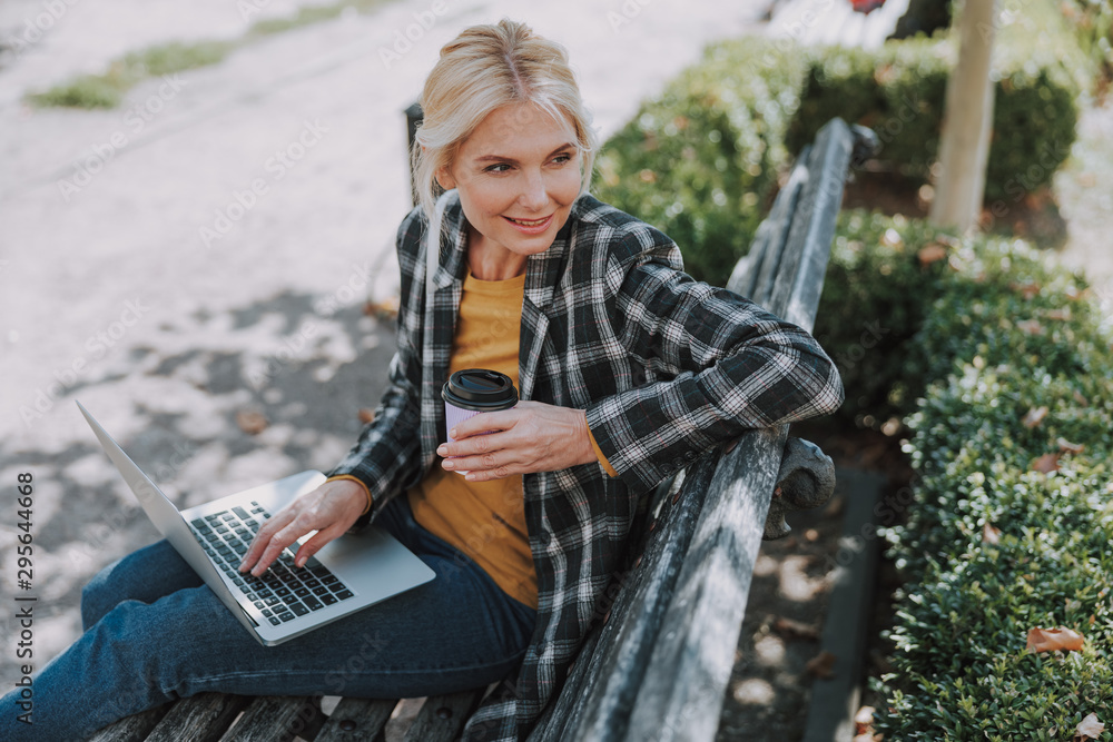 Woman with a laptop looking into the distance