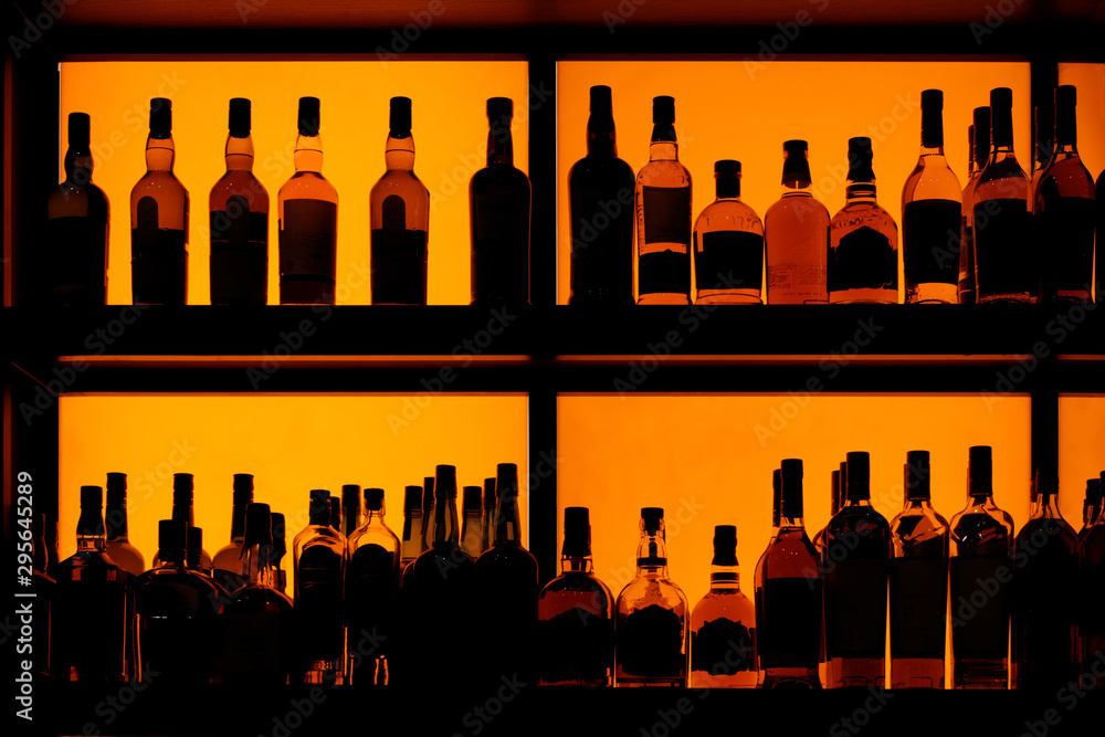 Bottles sitting on shelf in a bar Stock Photo | Adobe Stock