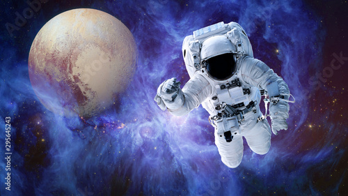 Fototapeta Naklejka Na Ścianę i Meble -  Alone Astronaut and fiction planet in outer space near the Sword of Orion and nystical fiction planet. Science fiction wallpaper. Elements of this image were furnished by NASA