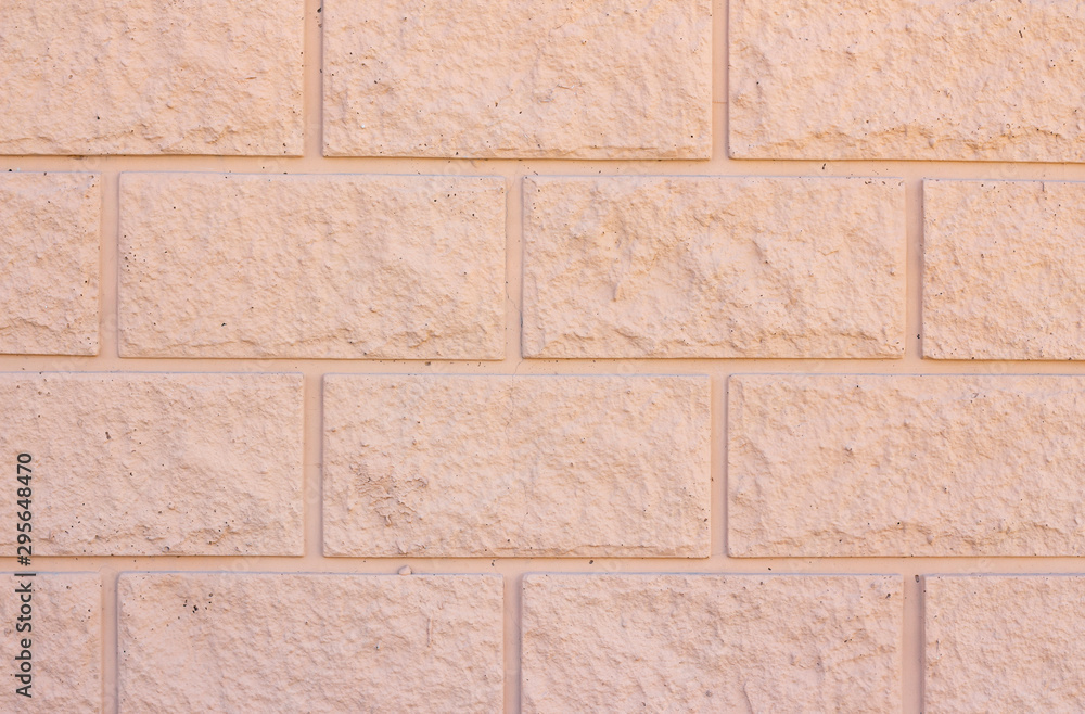 Fototapeta premium Brick wall background texture. Exterior wall decoration and design. beige