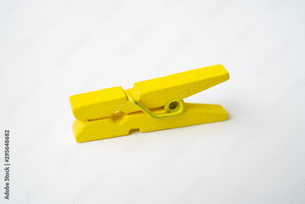 Yellow wooden clothespins on a white background. Yellow wooden clothespins on a white background.