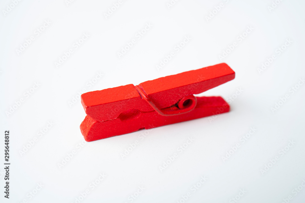 Red wooden clothespins on a white background. Red wooden clothespins on a white background.
