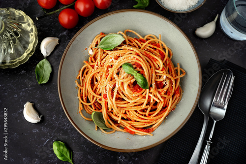 Fototapeta Close up of spaghetti with tomato sauce on black background