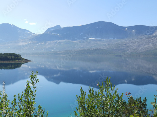 landscape with smoky mountains in the background and blue water in the foreground  beautiful blurry glare