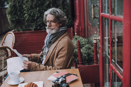 Serious man in glasses looking away outdoors stock photo