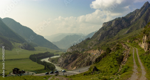 mountain modern road to the gorge where the river flows and the ancient stone path to the mountains photo