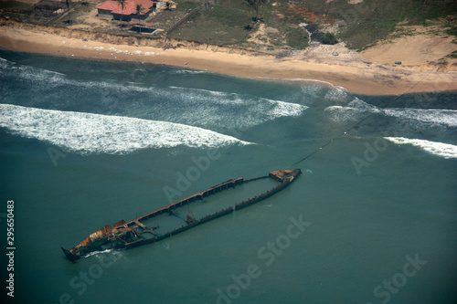 Aerial view of a rusty ship wreckage off the shore of Ghana © schusterbauer.com