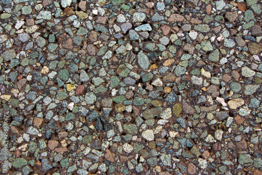 a piece of asphalt close up consisting of colored stones a piece of asphalt close up consisting of colored stones