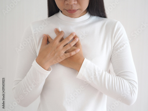 heart failure in woman and she press her chest symptom of pain and suffering cause of arrhythmia and bradycardia use for medicine product and health care concept on white background.