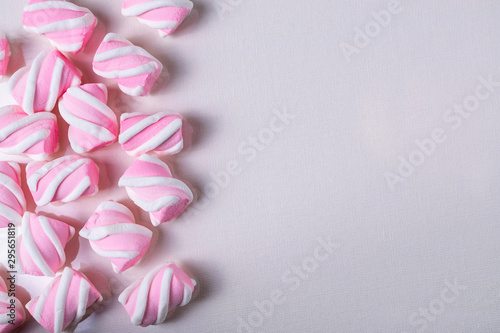 Background with pink tasty marshmallows. Flat lay overhead with copy space for your text