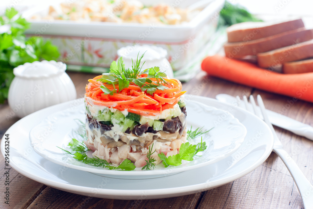 Salad with mushrooms, prunes, Korean carrots on a white plate, selective focus Salad with mushrooms, prunes, Korean carrots on a white plate, selective focus