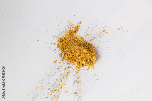 Gold eye shadows, shimmer crushed samples isolated on white background. Concept of makeup and beauty.