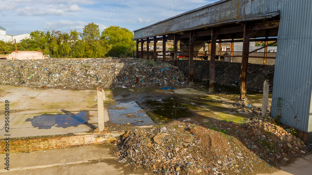 Aerial view of a warehouse destroyed by fire and filled with waste